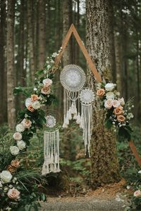 This dreamy a-frame ceremony backdrop features dreamcatchers + romantic blooms | Image by Storyteller Wedding