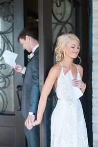 Reading love notes and letters before the wedding ceremony. Love this wedding letter idea! #weddingphotos #brideandgroom #weddingideas #weddingletters #firsttouch