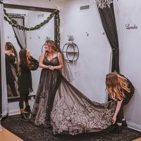 This unique black floral wedding gown might have you completely rethinking your "classic white" vibes! However, if you're still wanting something more traditional we have good news...it also comes in Ivory/Champagne accent over Blush or All Ivory! Click through to see which one is your fave! #blackweddinggown #vneckbridalgown #vbackweddingdress #watsonmaggiesottero #maggiesottero