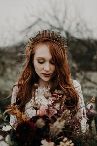 This bridal bouquet is full of deep red + dusty pink blooms perfect for this winter wedding | Image by The Quirky