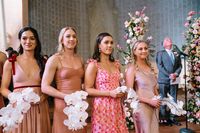 Single stem white orchid bridesmaid bouquets for a New Orleans garden style wedding ceremony at Hotel Peter + Paul by Leaf + Petal NOLA
