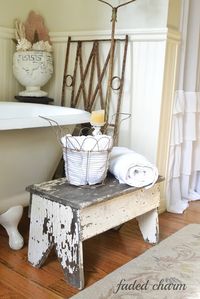 Faded Charm: ~A Romantic Vision~ | More sea life inside a white weathered urn along with a chandelier and iron piece, both with lots of patina fill this corner of the bathtub. |