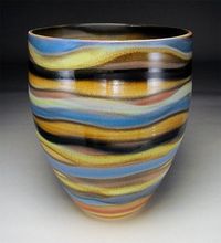 White stoneware, sometimes with porcelain slip for texture. Gas fired in reduction to Cone 10 or approx. 2350 F.