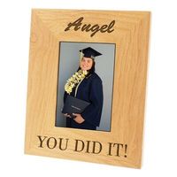 This personalized Alder photo frame features a light wood color with clean grain and joinery. It measures 8 x 10 inches and is perfect for framing 5 x 7 photos. It comes with a glass panel and a fold back easel stand, allowing for horizontal or vertical display. Have it personalized with a name, message, or caption in two lines for free.
