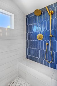 Stunning Blue Settecento Crayons tile with Brass Hardware. Light Gray countertops. White shower. #masterbathroom #bathroom #bathroomideas #bluetile #brasshardware #bathrooms #bathroominspiration #sconces #shower #shower ideas