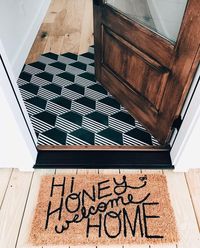 bold mosaic tiles in black and white with a hex shape and light colored laminate with a sharp transition