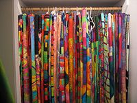 hang large quilts in a closet with heavy duty pants hangers.