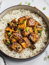 Garlic Tofu Stir Fry {Vegetarian} | This easy, healthy garlic tofu stir-fry recipe is loaded with authentic flavor and tastes better than take out. Soft on the inside, with a light golden crisp on the outside and coated with a sticky garlic sauce, this pairs perfectly with cooked veggies or your favorite rice. Can be made vegan as well. #tofurecipe #asianfood #garlictofu #chinesefood
