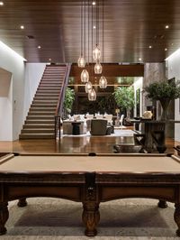Which celebrity owns this architectural gem with striking features & Instagram-worthy interiors? We'll give you a hint: this pool table was used by an Academy Award-winning actor that's close friends with Ben Affleck.