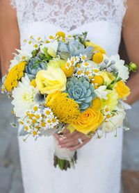 This yellow bouquet with daisies, roses, billy balls, and succulents is perfectly balanced