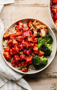 This Gochujang Tofu recipe tosses crispy baked tofu bites in a red chili sauce. Each bite is spicy, savory, and packed with flavor! It’s an easy dish you can serve in rice bowls, stir fries, noodle bowls, tacos, and more.