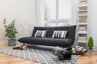 Place a downy quilt or featherbed on top of the futon mattress for the guests so that they can sleep in comfort. Image Courtesy, GoodMood Photo/Shutterstock