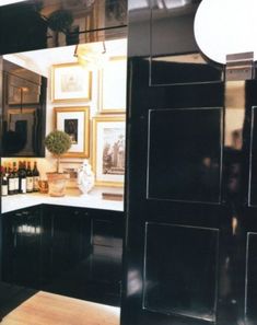 my dream NYC pied a terre kitchen: black, cream and gold accents with art