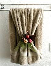 18 Effective Ways To Organize Your Bathroom Decor This Bathroom Towel Decor Is Simply A Sheer Green Organza Ribbon Tied In Bow Around One Layer Of The With Pomagranate Pick Placed Behind