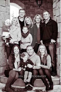 large family/group pose -framed in the opening of architecture