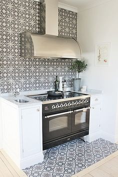 this patterned tile is the focal point in this white kitchen cool