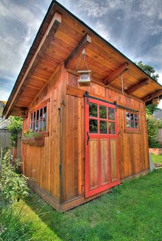 Garden Sheds With Windows shed with dark grey wood siding and white doors. | gardening Garden Sheds With Windows shed with dark grey wood siding and white doors. | gardening