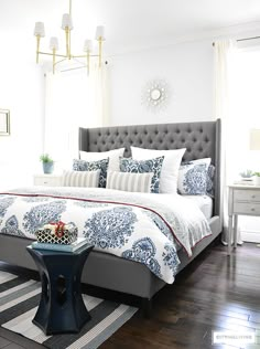 Blue and white Summer decorated bedroom with layers of bold pattern - batik, stripes and paisley - bring a casual, coastal look. Upholstered headboard with nailhead trim is classic and elegant. Light blue walls keep the look crisp and airy. Bedroom Furniture, Bedroom Colors, White Bedroom, Elegant Bedroom Decor, Guest Bedroom Design