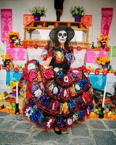 beautiful day of the dead outfit featuring a brightly coloured mexican dress and sugar skull makeup da de los muertos la catrina