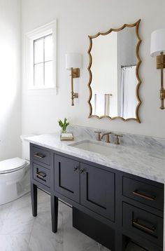 Most Por Cabinet Paint Colors Ideas For The House Pinterest Antique Br French Sconces Flank A Gold Leaf Vanity Mirror Hung Over Black Washstand Accented With Pulls And White Gray Marble Countertop