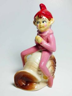 Seated Baby Green Elf Pixie Leprechaun Figurine Holding Shamrocks Clovers Peapod Green Suit Flower Hat Brown Hair Japan 1970s
