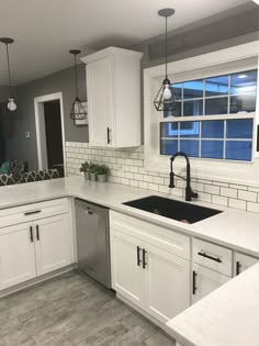 White shaker cabinets with solid surface countertops and flat black handles. Backsplash Kitchen White Cabinets, Kitchen Flooring Options, Kitchens With White Cabinets, Kitchen With Grey Floor, Modern Farmhouse Kitchen Backsplash, White And Grey Countertops, White Kitchen Cupboards, White Cabinet Kitchen