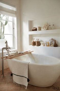 love the large white tub with the in-wall shelving #bathroomdesign #bathroomdecor #modernhome