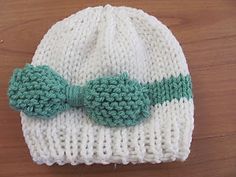 Knitted baby hat with bow. CHANGE TO 50 CO sz 8 needles. 5 INCHES BEFORE DECREASES. CO 40 on sz 6 needles for newborn. 4 rows ribbing, 4" before decreases.