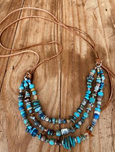 Seaside necklace simply elegant every day upcycled water bottle holding a dyed magnasite tear drop shaped stone turquoise color.
