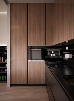 a kitchen with wooden cabinets and black counter tops, along with an oven in the middle