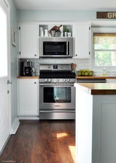 P Up The Cabinets Above Stove To Make More Room For Range Hood This Farmhouse Kitchen Is Both Functional And Inviting Stainless Steel Liances Bring A Professional Look While Adding Softer