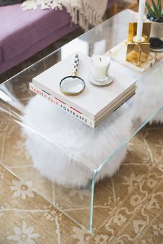 round upholstered tufted ottoman tucked under acrylic coffee table round upholstered tufted ottoman tucked under acrylic coffee table