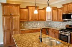 custom luxury eat in kitchen with granite counters oak cabinets