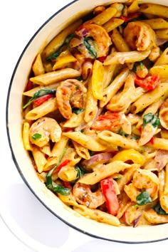 This Cajun Shrimp Pasta recipe is made with the most delicious creamy alfredo sauce, colorful veggies, and zesty shrimp (or chicken, sausage, or your preferred protein). It's comfort food with a kick! | gimmesomeoven.com #pasta #cajun #shrimp #dinner #recipe #alfredo #sauce