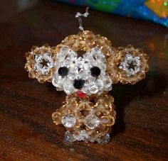 ummmm...i made this a while ago it's just a random..monkey thing..made out of swarovsky beads and fishing line..and it's only like 2 inches tall or something..