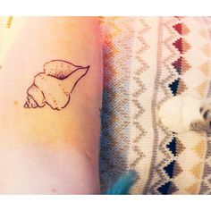 shell tattoo in white to look like a birthmark of a mermaid as shell tattoo in white to look like a birthmark of a mermaid as
