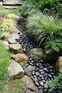 This Is A Lovely Dry Rock Bed Really Like The Mix Of Natural Rocks This Is A Lovely Dry Rock Bed Really Like The Mix Of Natural Rocks And Polished Black River Stones Pinterest Garden Creek