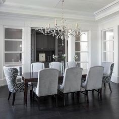 Gray dining room features a tray ceiling accented with a satin ... Gray dining room features a tray ceiling accented with a satin ...
