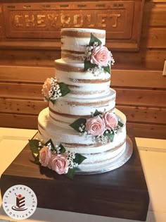 Wedding Cake Loveliness A Naked Style With Artificial Flowers On Dark Wood Wedding Cake Loveliness A Naked Style With Artificial Flowers On Dark Wood