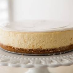 Perfect Cheesecake with Graham Cracker Crumbs, Sugar, Salt, Unsalted Butter, Cream Cheese, Granulated Sugar, Salt, Vanilla Extract, Large Eggs, Sour Cream, Heavy Whipping Cream, Sour Cream, Powdered Sugar, Vanilla Extract, Fresh Raspberries, Granulated Sugar, Water.