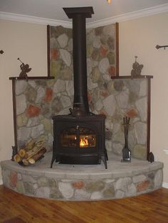 Like the set-up, not the color of stones or trim. Corner wood burning stoves - Google Search Wood Burning Stove Corner, Corner Stove, Corner Fireplace