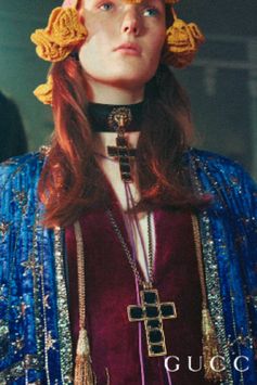 In an historic Italian ballroom in Turin, the Gucci Gift campaign unfolds. New Gucci Jewelry pieces include necklaces featuring pendants embellished with enamel details.