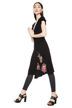 Women's black short-sleeved V-neck dress with contrasting floral embroidery. Flared skirt and fitted waist. It´s all about dresses and you can discover Desigual dresses selection on our website.
