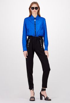 Louis Vuitton Cruise 2018 - Look 14 This look captures the season's casual yet fashionable silhouette, with a distinctively utilitarian feel. A shirt collar lends a sophisticated touch to the jacket, while the fluid pants have a sportswear feel.