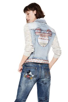 Women's denim jacket with Mickey Mouse embroidery on the back. Knit sleeves and contrasting details. Discover this jacket in more details on Desigual website.