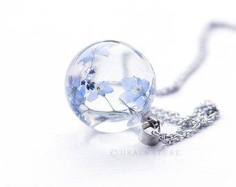 Delicate blue resin pendant with real dandelion seeds: