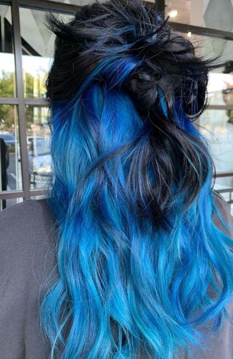 Peekaboo blue highlights under black hair showing when hair moves