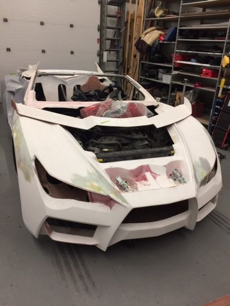 Picture of custom carbon fiber car being assembled and painted at