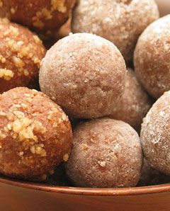 Rum Balls ~ 1 6-ounce bag of Nestle Toll House semisweet chocolate chips. 3 tbs light corn syrup. 1/2 cup dark rum or bourbon. 2.5 cups vanilla-wafer crumbs (run them through a food processor to get the right consistency). 1/2 cup confectioner's sugar. 1 cup finely chopped walnuts (or whatever nut you prefer)... Boozy and Sweet!