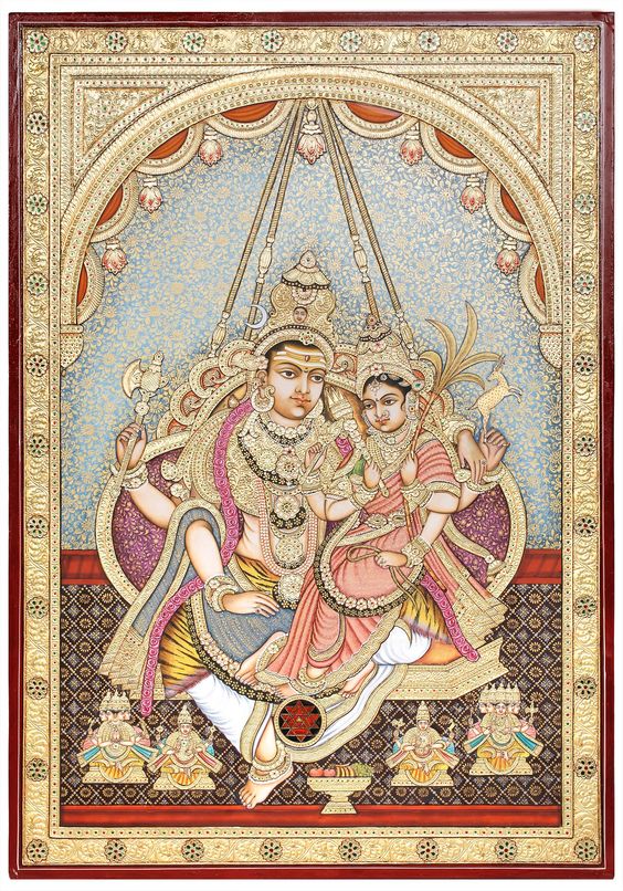 Tanjore Painting on BoardTraditional Colors with 24 Karat GoldArtist: Kailash Raj - Lord Shiva With Devi RajarajeshwariLord Shiva is in the company of the arrestingly beautiful Devi Rajarajeshwari. She is the Tripura Sundari, a particularly beautiful manifestation of Devi Parvati. Despite His pristine dhoti and the world of adornments on His person, the tigerskin loincloth of Lord Shiva is in place. She is clad in a saree the colour of peaches, which almost blends into Her roseate skin. In keepi